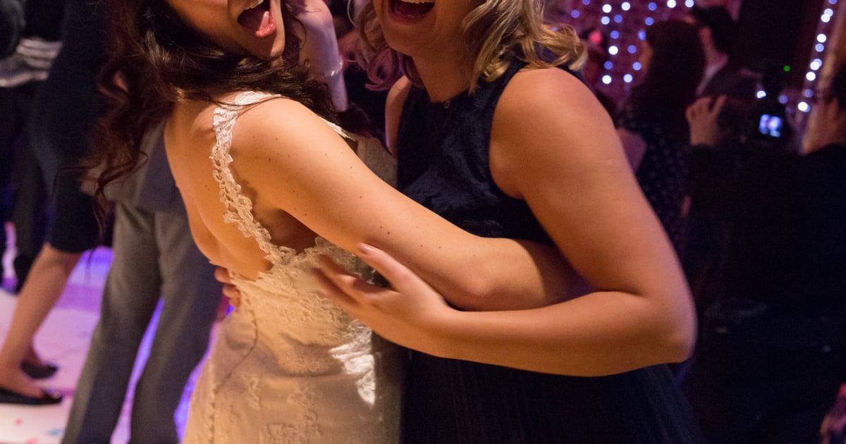 Bride and guest sharing a joyful embrace at a wedding reception