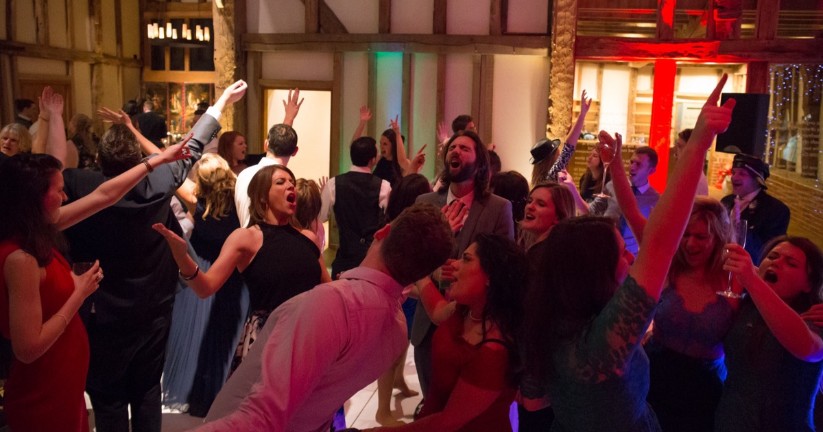 Wedding dancefloor with guests dancing together rather than looking at lights