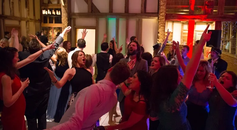 Wedding dancefloor with guests dancing together rather than looking at lights