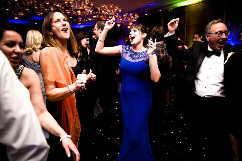 Energetic wedding guests celebrating on the dance floor