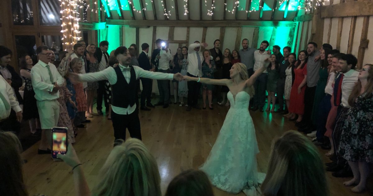 Couple dancing playfully at their wedding reception at Bromley Court Hotel