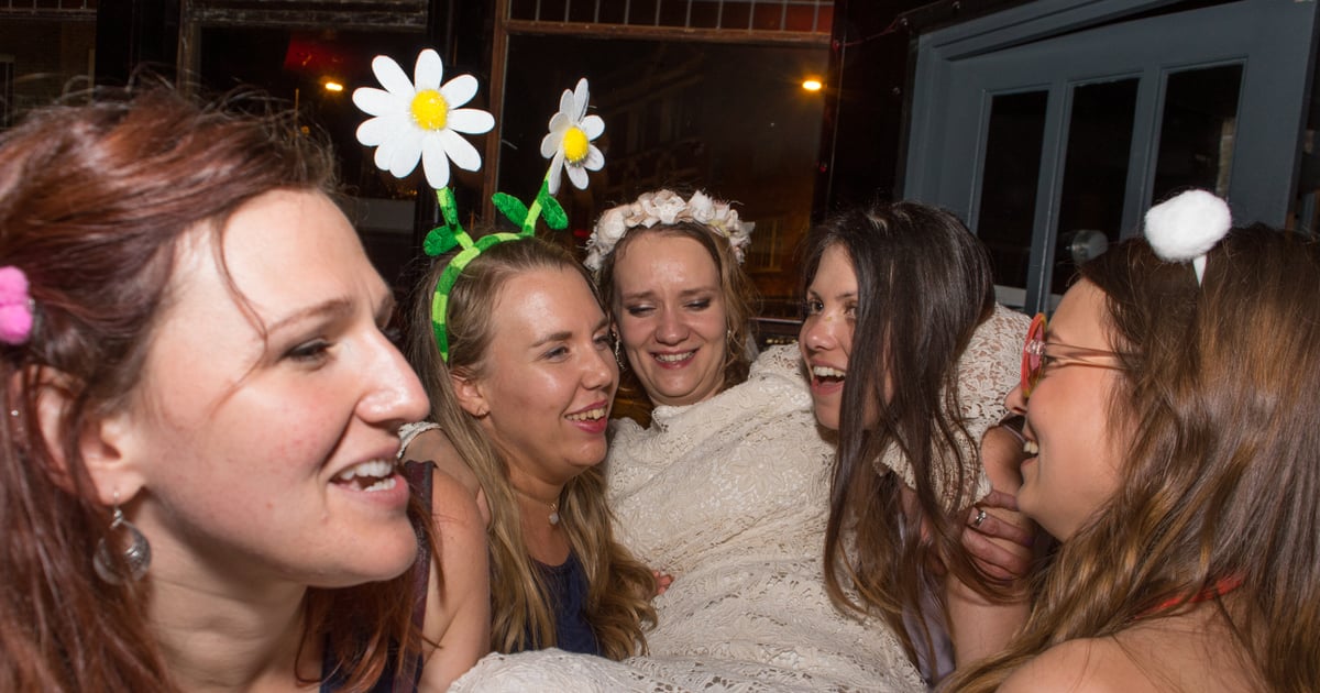 Bridesmaids and bride laughing together at a wedding