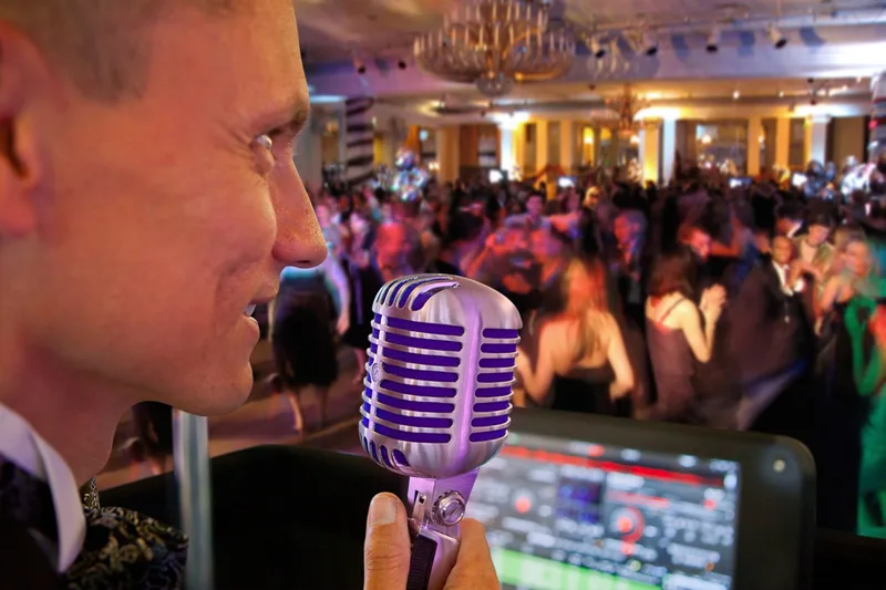 Professional DJ selecting music during a wedding reception