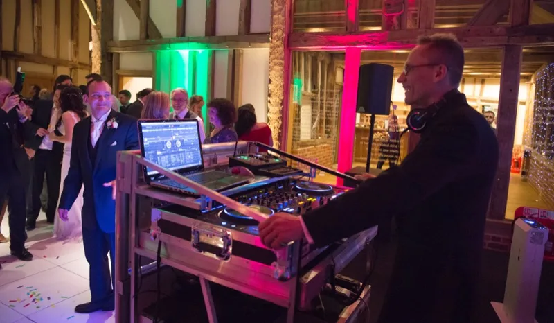 Professional DJ equipment with multiple backup devices ready for a wedding