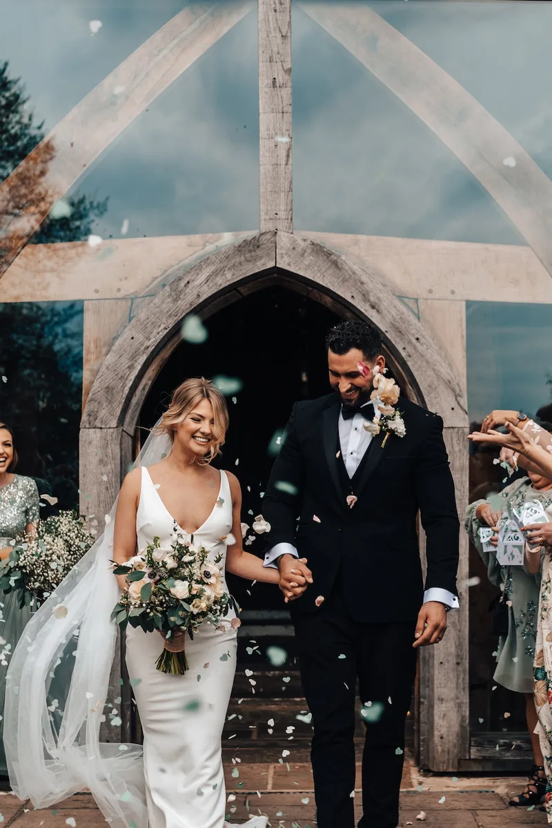 Exterior of Cripps Barn surrounded by greenery and rustic charm