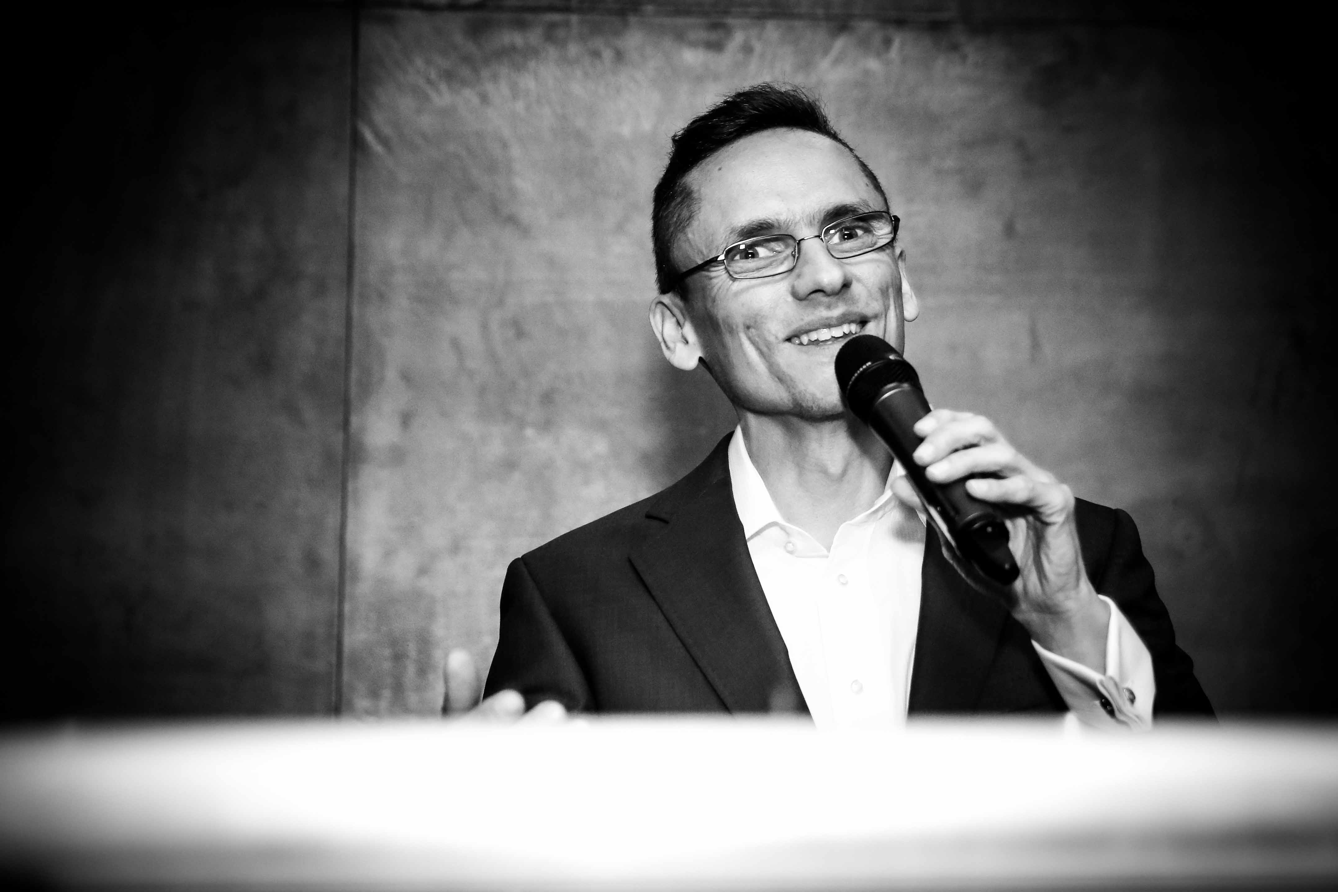 Wedding Host making an announcement with a microphone and smiling guests